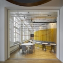 Single glass wall in an aluminum frame. Company slogan on the glass
