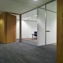 Single glass wall, wooden door and a glass door