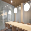 Conversation room with single glass system wall with dotted print.