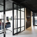 Sliding door in a industrial look glass wall