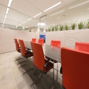 Conference room with single glass wall and wood panels