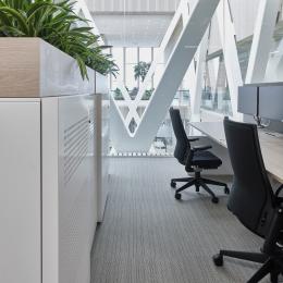 Office space with in the background a QbiQ Safety Glass partition