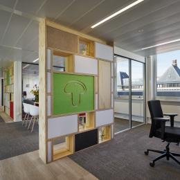 Circular office wall made of reused materials.