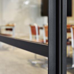 Closeup of an industrial look & feel glass office wall
