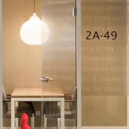 Full glass partitions wall with text design film added