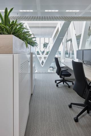 Office space with in the background a QbiQ Safety Glass partition