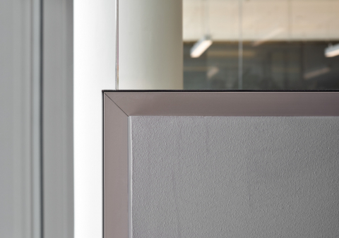 Corder detail of a partial glass and partial closed wall