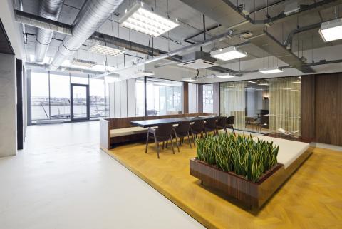 Large open space divided in smaller offices with glass demountable walls.