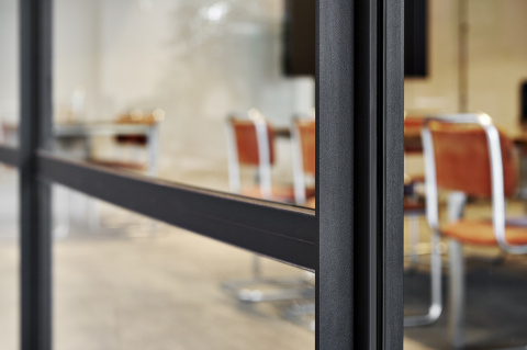 Closeup of an industrial look & feel glass office wall