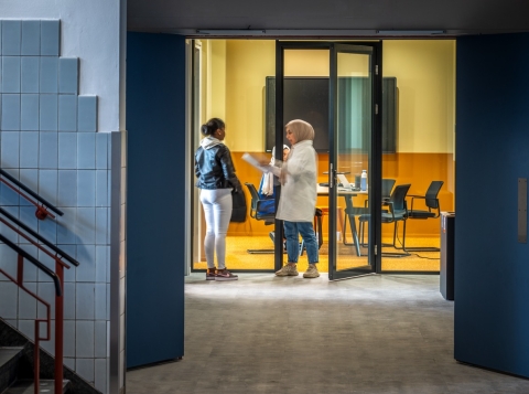 Hallway with glass partitions and door at the end