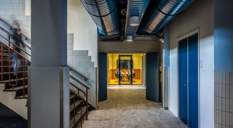 Hallway with glass partitions and door at the end